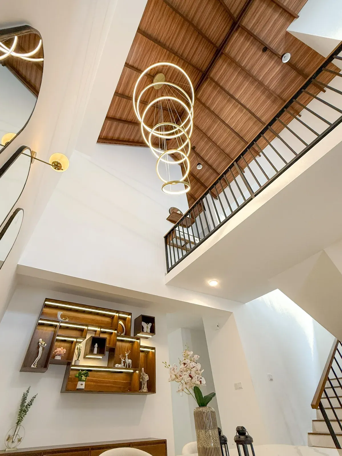 Double-height stairwell with timber-clad raked ceiling